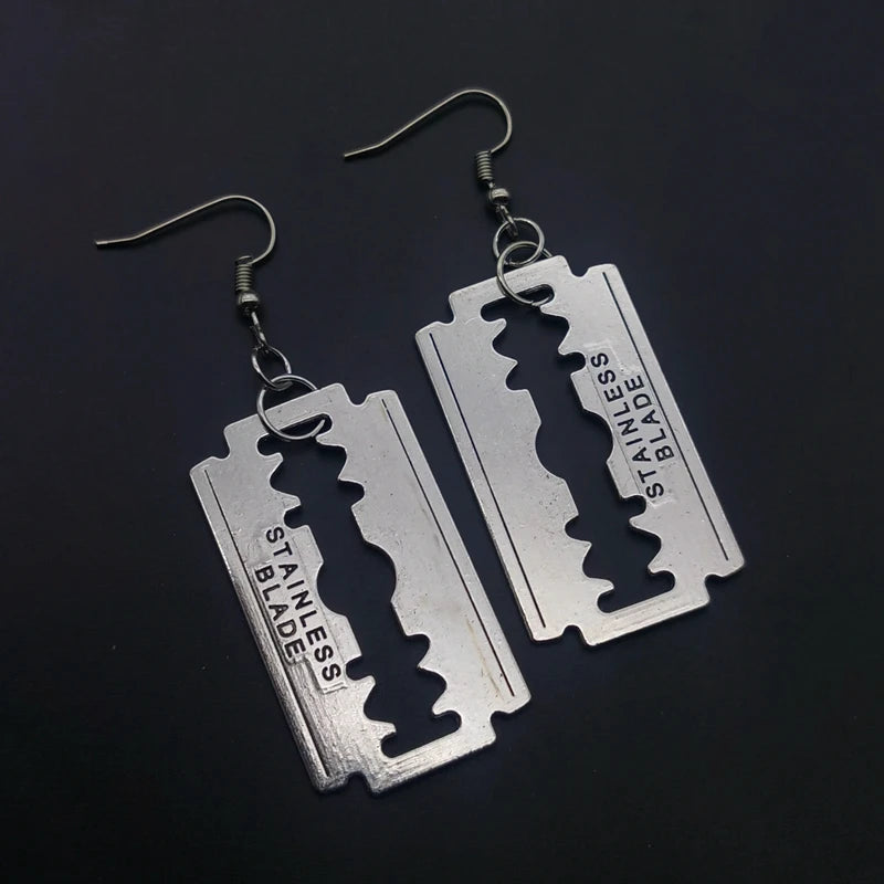 Edgy razor blade earrings for men and women featuring a 90s grunge goth punk aesthetic, made by PressureDen.store.