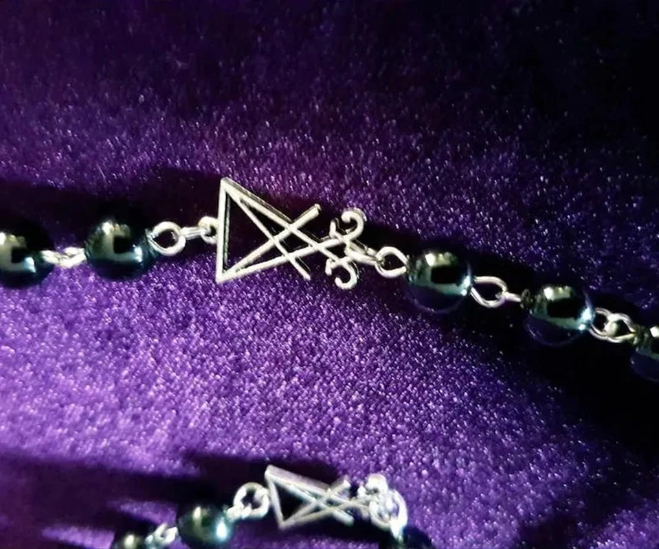 Luciferian Sigil Rosary Necklace showcasing gothic occult jewelry with dark metal beads and detailed sigil pendant.