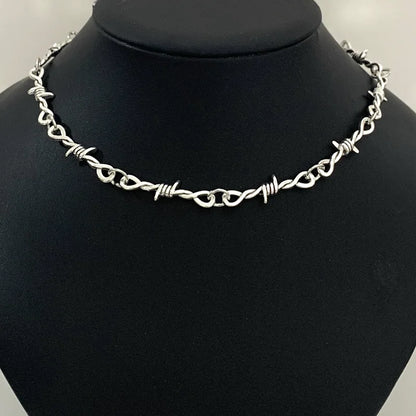 Gothic heart choker necklace with barbed wire design, hip-hop inspired edgy jewelry for women, black metal accessory.