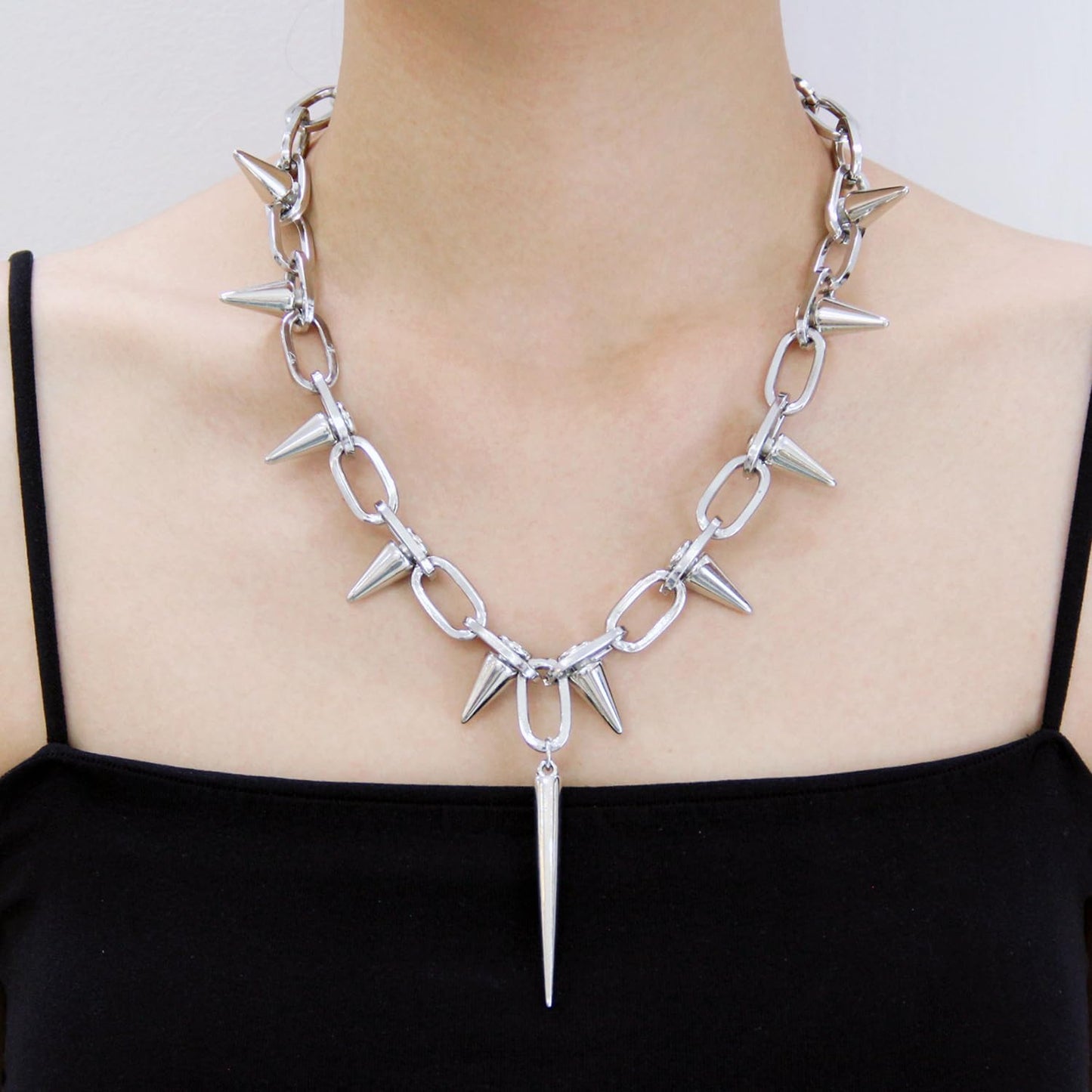 Silver spiked choker necklace with rivets and chain detail, unisex goth jewelry perfect for parties and nightclubs.