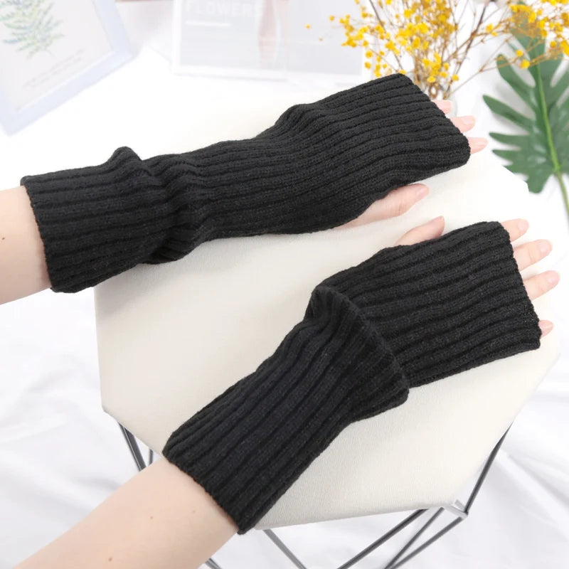 Chic women's long fingerless gloves by PressureDen.store, cozy winter arm sleeves suitable for goth and punk fashion styles.