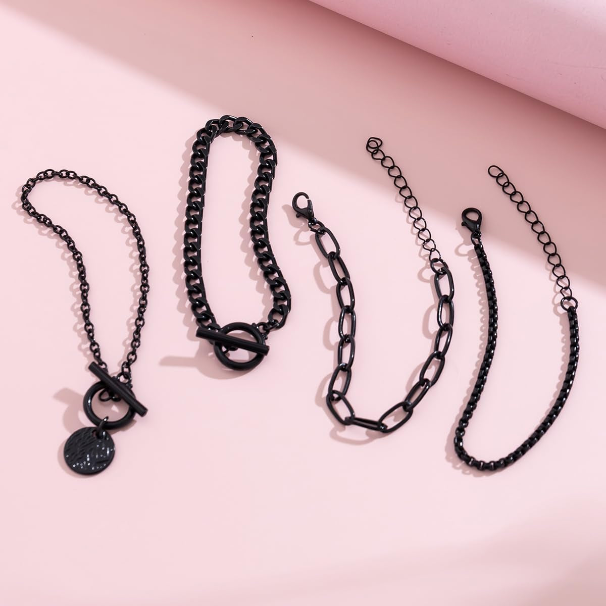 Stackable black Gothic bracelets set with gold coin charms and vintage chains from SAVNOJW, ideal for Y2K parties and Halloween.