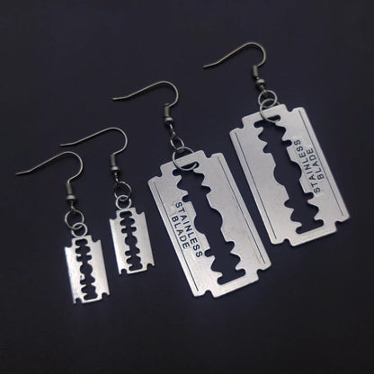 Edgy razor blade earrings for men and women featuring a 90s grunge goth punk aesthetic, jewelry from PressureDen.store