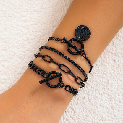 Stackable black bracelet set by SAVNOJW featuring gold coins and vintage chains, ideal for Gothic, Y2K, or Halloween accessories.