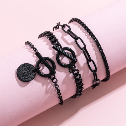 Stackable black Gothic bracelets set by SAVNOJW with gold coins and vintage chains, ideal for Y2K parties and Halloween accessories.