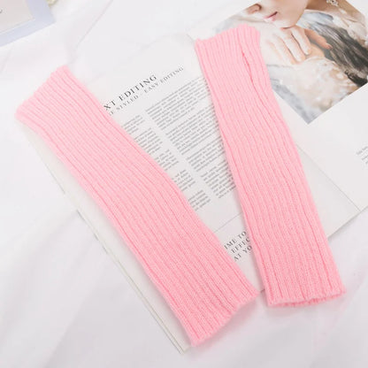 Long black fingerless gloves for women, cozy winter arm sleeves with goth and punk style, made by PressureDen.