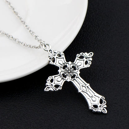 Gothic vintage cross pendant necklace with edgy Y2K grunge chain jewelry for men and women, featuring a dark metallic finish.
