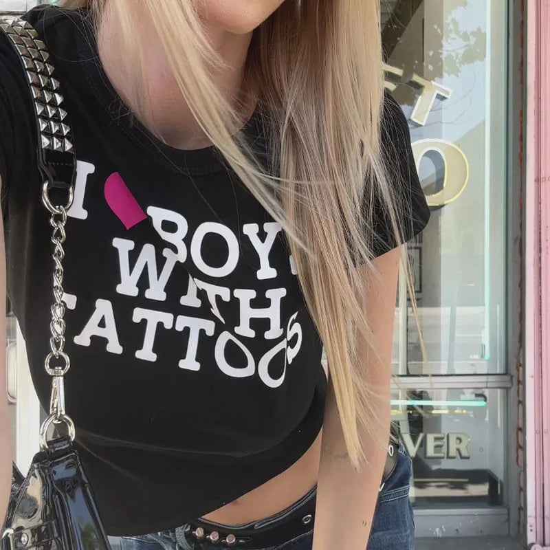 Aesthetic goth graphic crop top with 2000s Y2K Harajuku style, featuring bold black and white designs, worn by a fashion-forward model