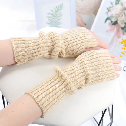 Long black fingerless gloves for women by PressureDen.store, cozy winter arm sleeves with goth and punk style details.