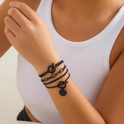 Stackable black bracelets set by SAVNOJW featuring gold coins and vintage chains, perfect for gothic fashion, Y2K parties, or Halloween.