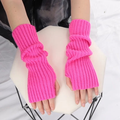 Cozy black long fingerless gloves for women, stylish winter arm sleeves with goth and punk fashion appeal.