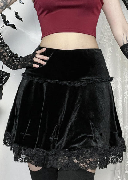 High waist black gothic velvet mini skirt for women, featuring punk grunge emo fashion style with a fitted silhouette.