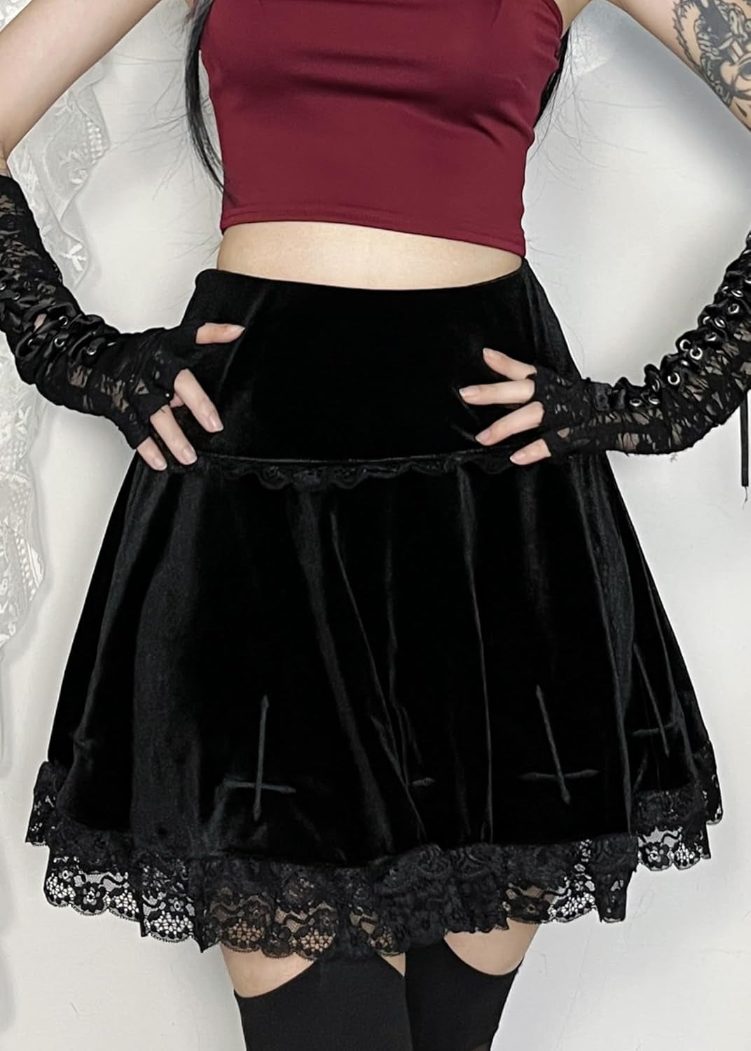 Black gothic velvet mini skirt for women, high waist punk grunge emo fashion style, shown on a model with a dark background.