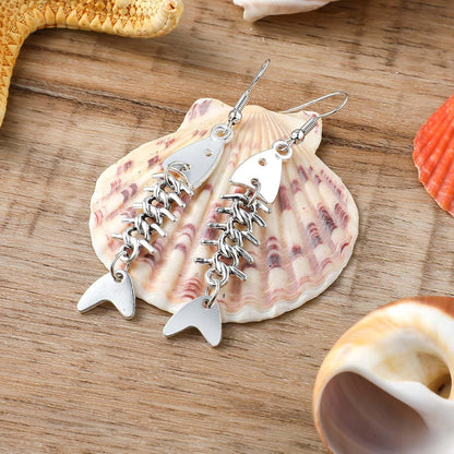 Pair of Yuanchu long fish bone dangle earrings made of zinc alloy with punk goth style for women.