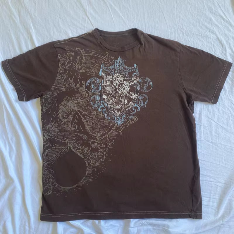 Brown retro Y2K graphic T-shirt from PressureDen.store featuring goth cyber grunge style, short sleeves, and vintage emo design.
