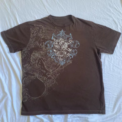 Brown retro Y2K graphic T-shirt from PressureDen.store featuring goth cyber grunge style, short sleeves, and vintage emo design.