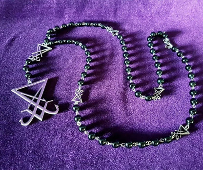 Luciferian sigil rosary necklace with gothic occult design, featuring dark metal beads and intricate symbols for left hand path jewelry.