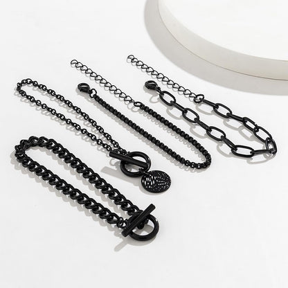 Stackable black bracelets set by SAVNOJW featuring gold coin accents and vintage chains, ideal for gothic, Y2K, or Halloween styles.
