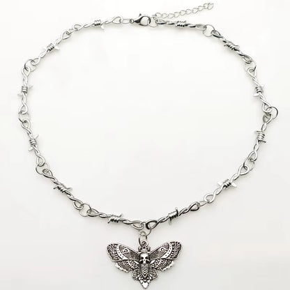 Gothic moth skull barbed wire choker necklace with small thorns, edgy punk jewelry for Y2K vampire style, black metal chain.